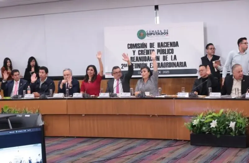 Officials raising hands at finance committee meeting