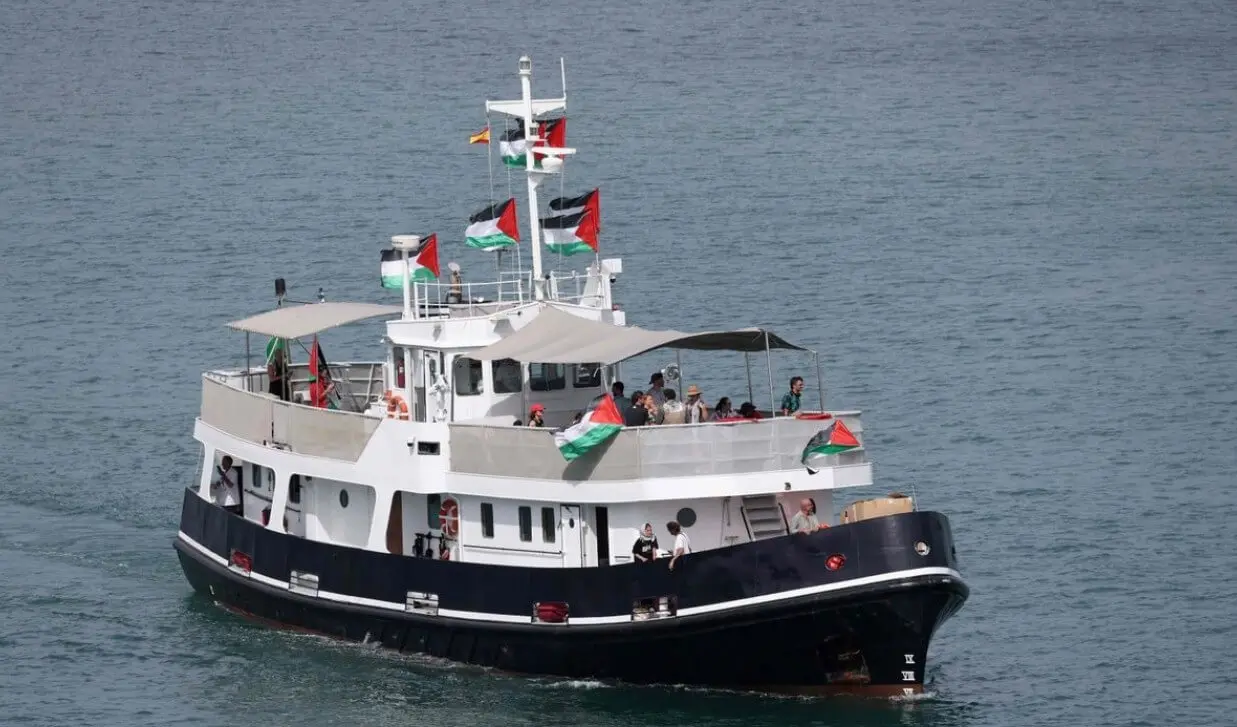 Black and white ferry flying colorful flags