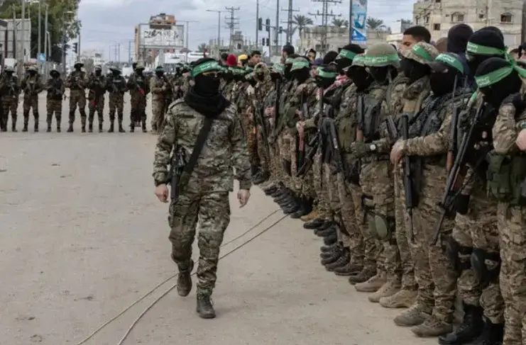 Masked armed fighters in camouflage formation