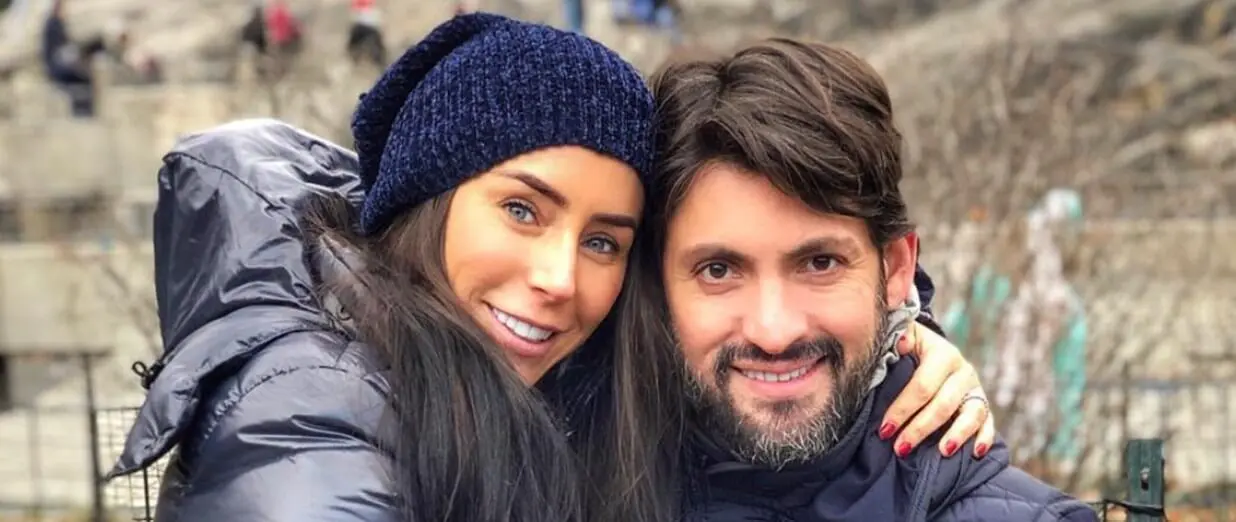 Smiling couple embracing outdoors in winter coats