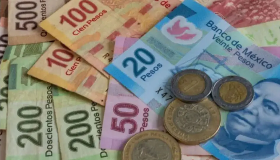 Mexican pesos banknotes and coins spread out