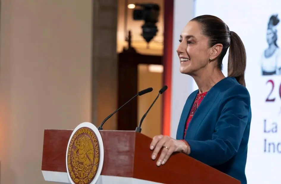 Smiling woman speaking at podium with seal