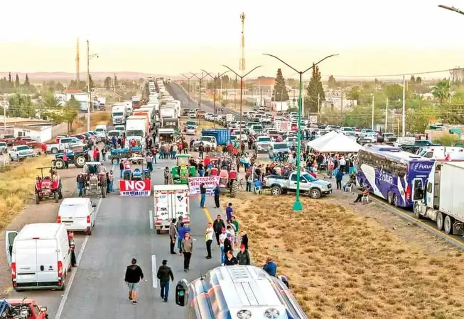 Blocked highway protest with trucks and crowds