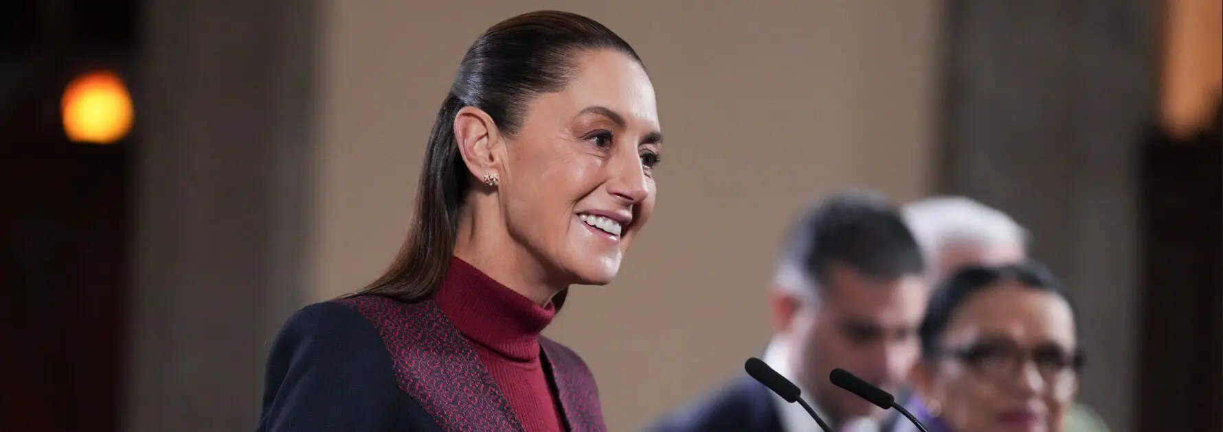 Smiling woman speaking into multiple microphones