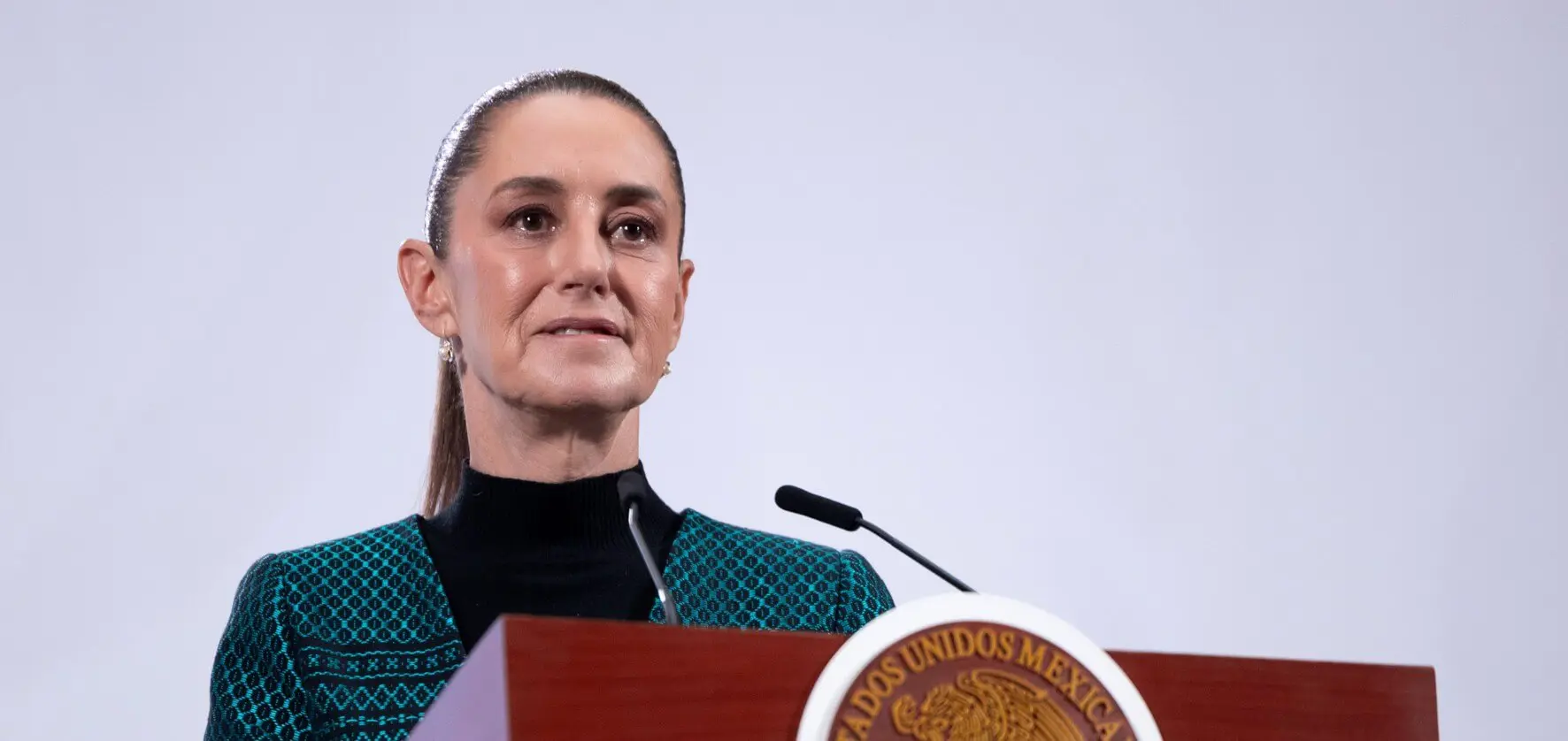 Woman speaking at government podium with microphone