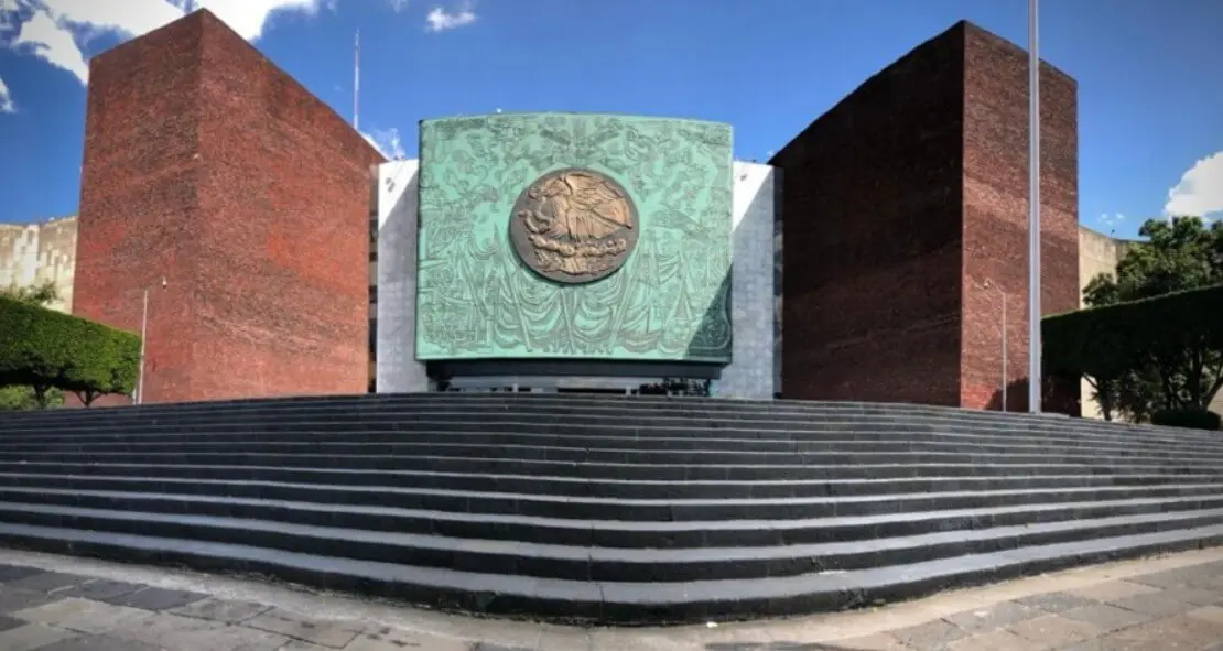 Wide stone steps to bronze emblem facade