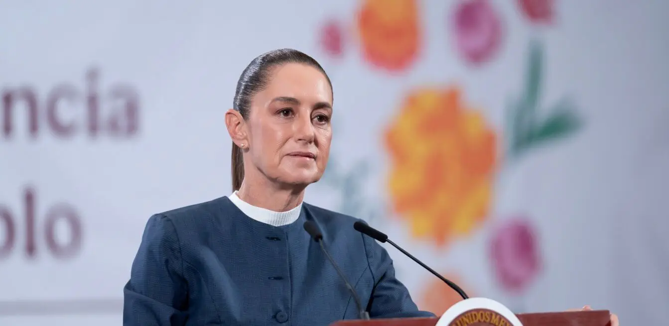 Woman speaking at podium with floral backdrop