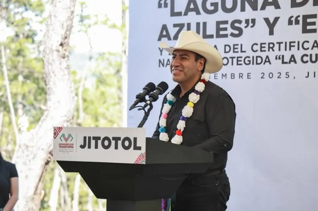 Man in cowboy hat speaking at podium