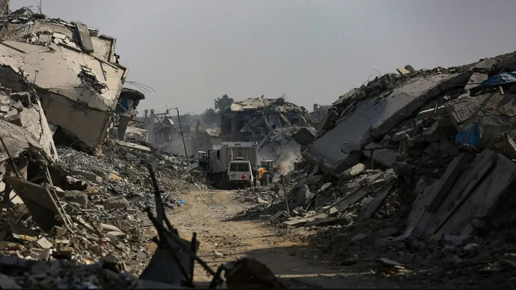 Truck amid rubble on heavily destroyed street