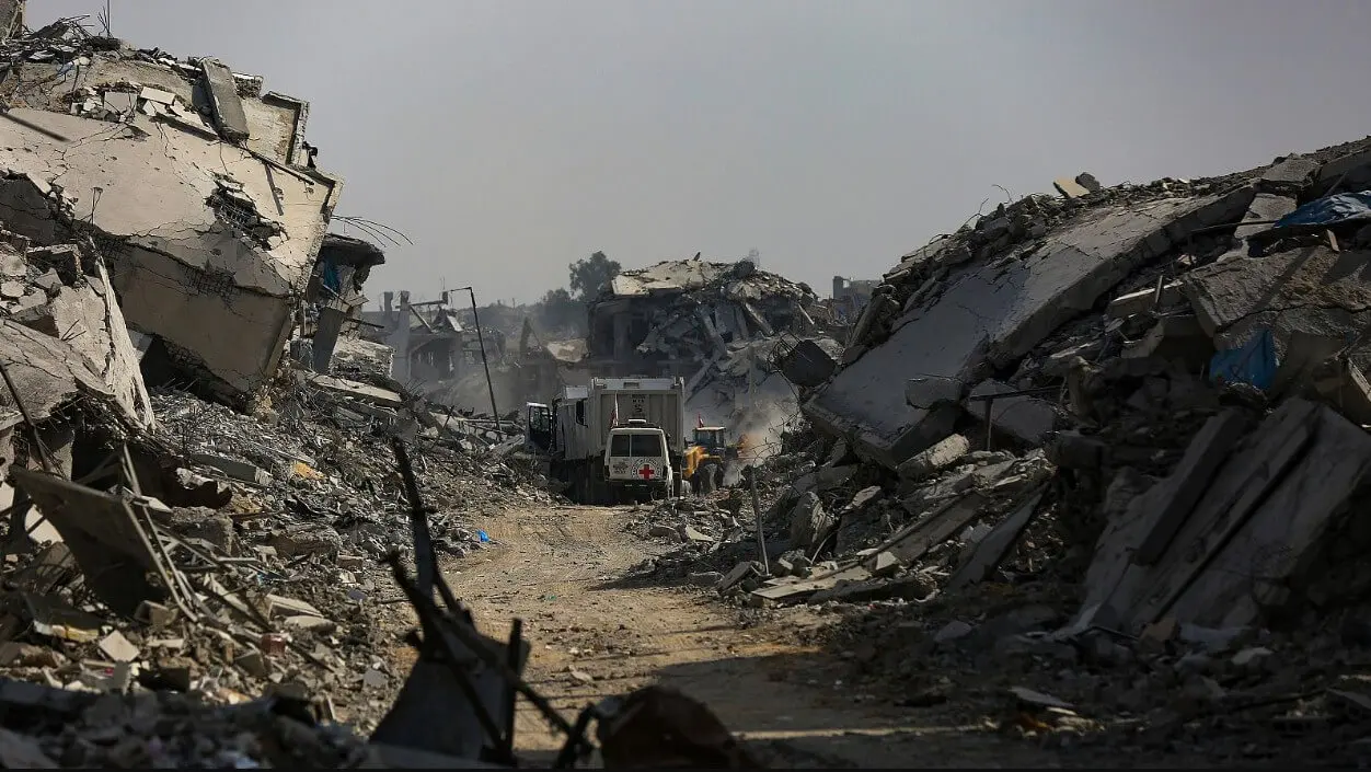 Truck amid rubble on heavily destroyed street