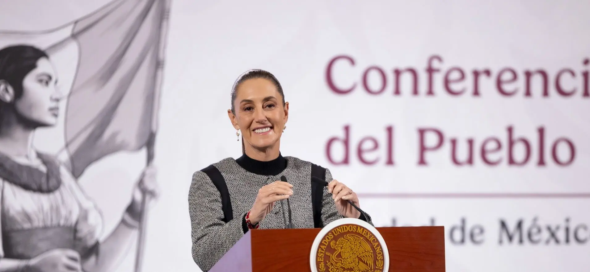 Smiling woman speaking at conference podium