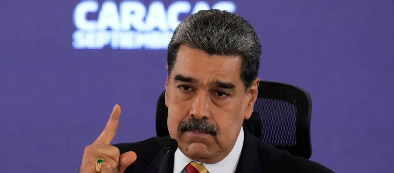 Man gesturing while speaking at podium
