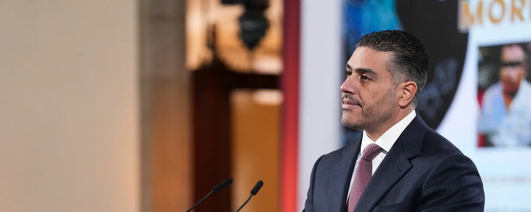 Man in suit speaking at podium
