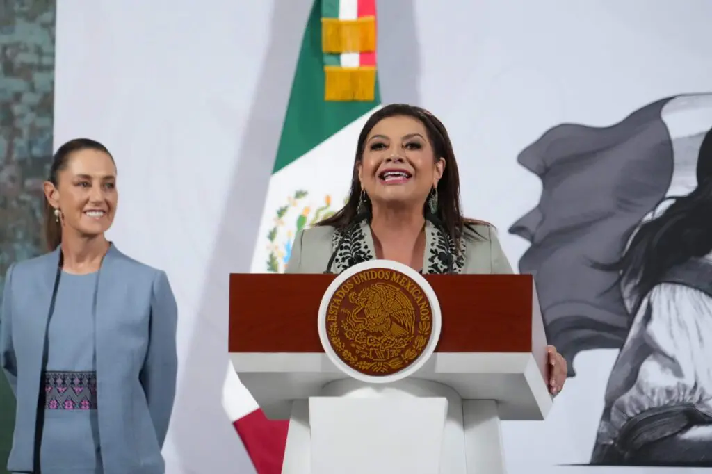 Woman delivering speech at Mexican flag podium
