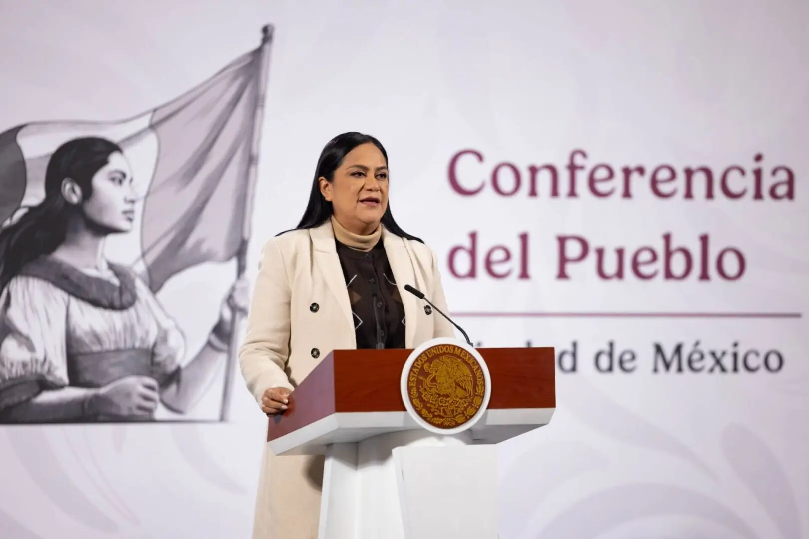 Woman speaking at Mexico conference podium