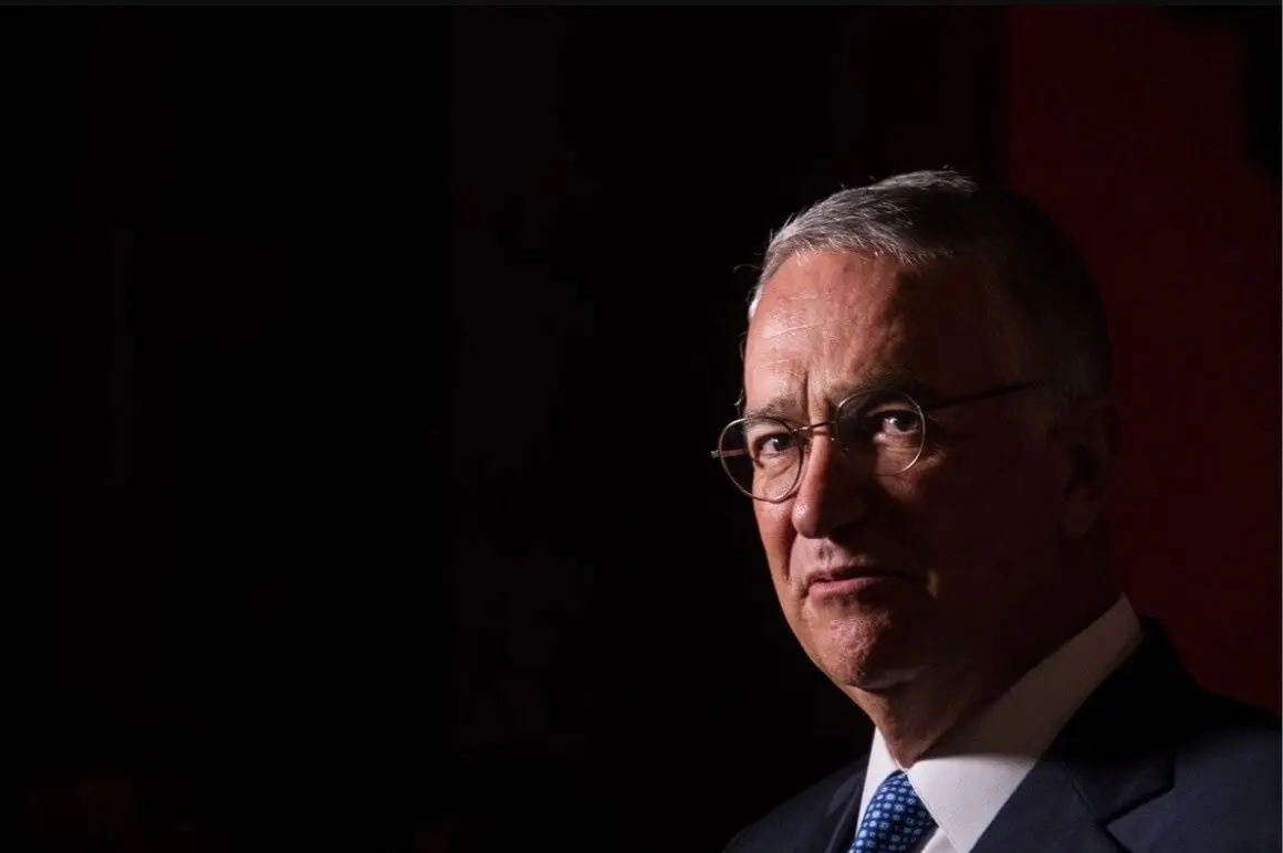 Pensive older man in suit, low-key lighting