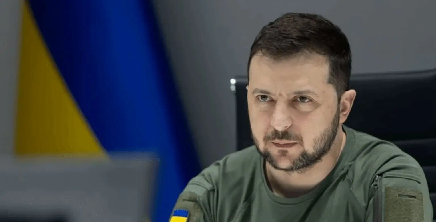 Serious man in green shirt, Ukrainian flag