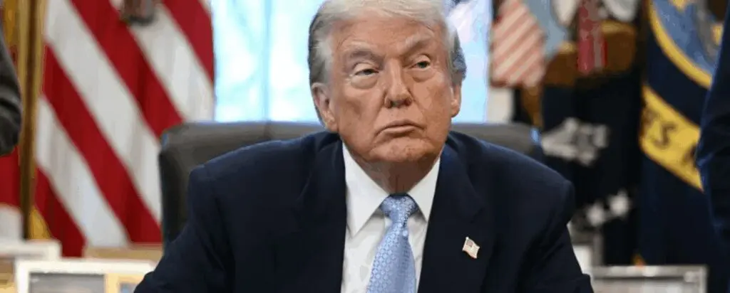 Seated man in suit with American flags