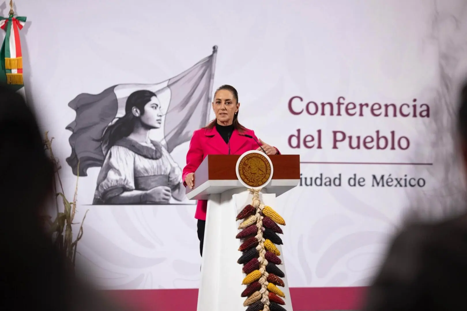 Woman speaking at Mexican conference podium