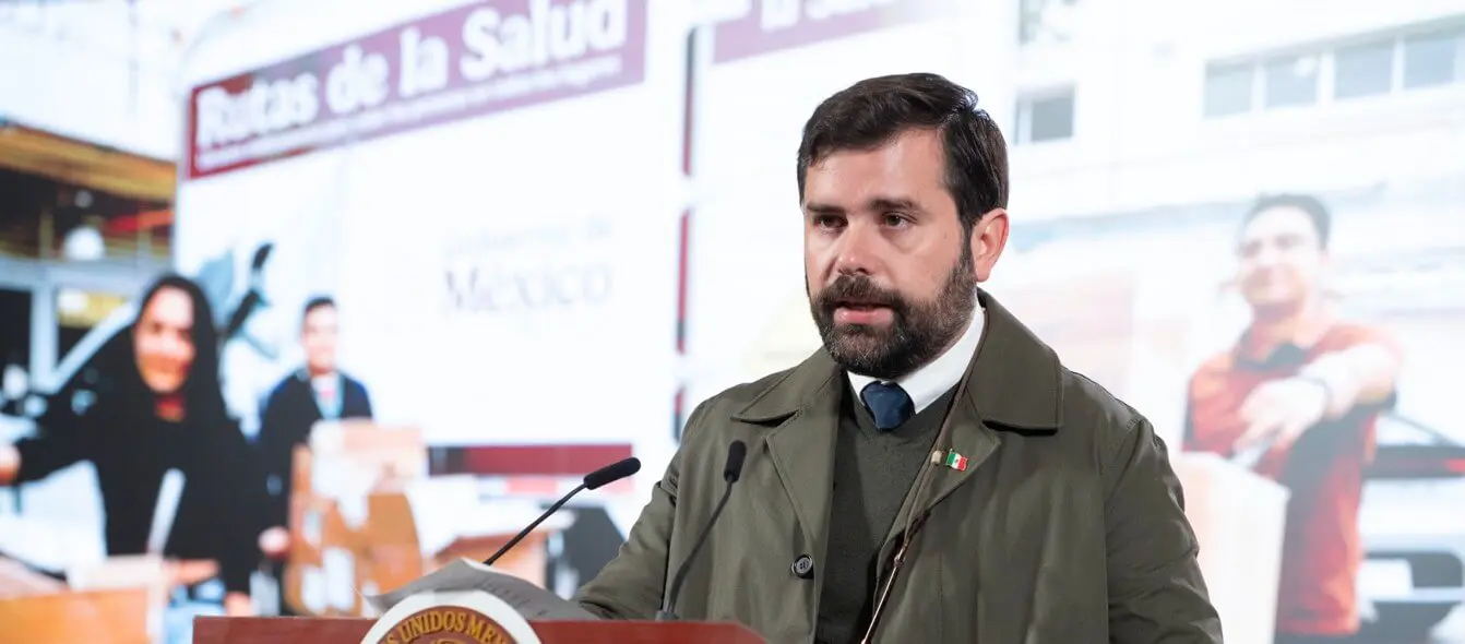 Man speaking at podium with health backdrop