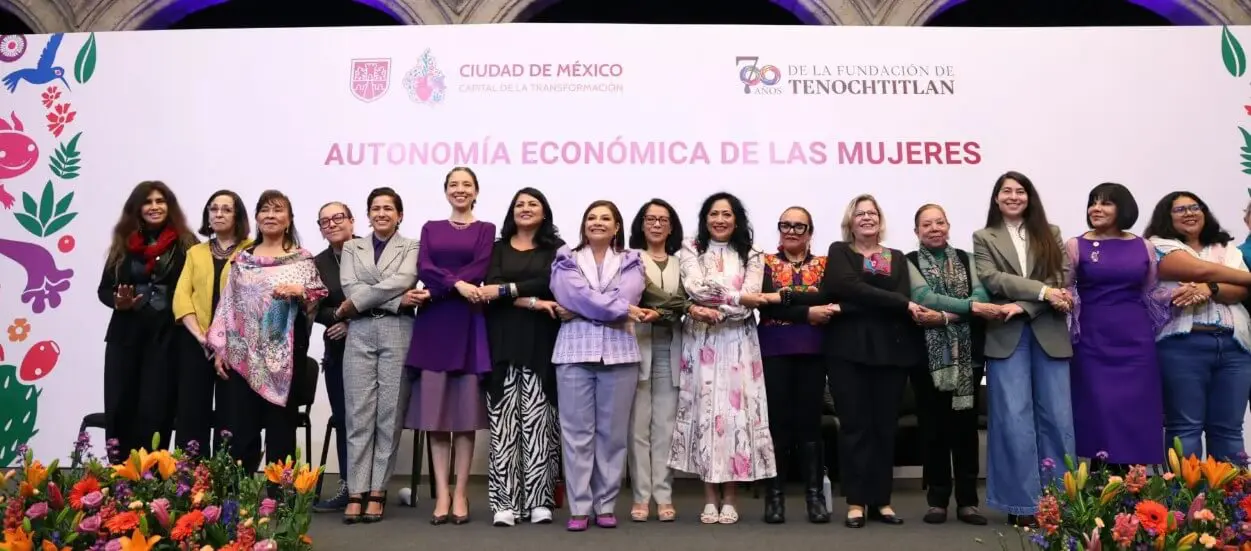 Women advocating economic autonomy on stage