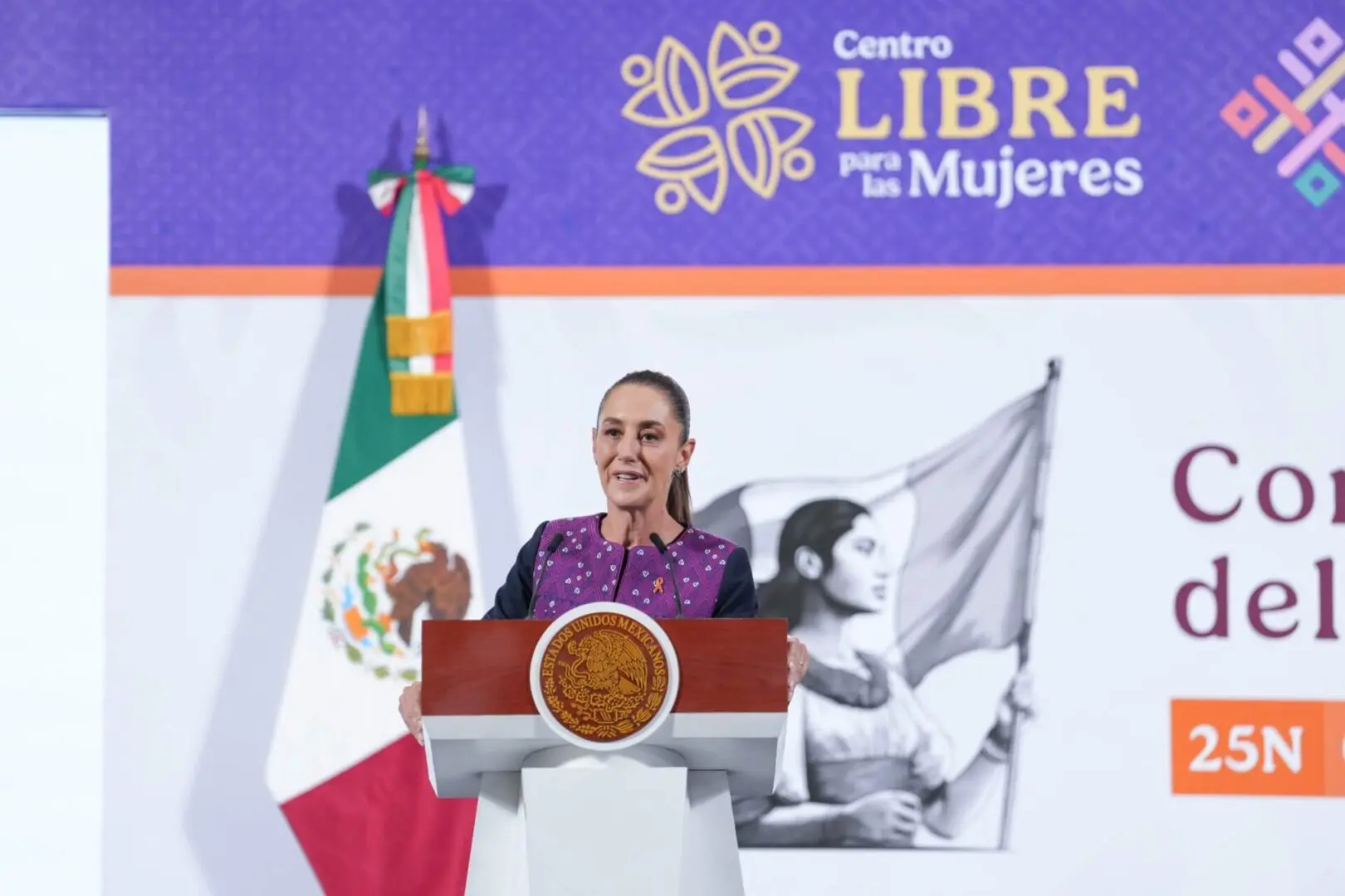 Woman speaking at Mexican women's center podium