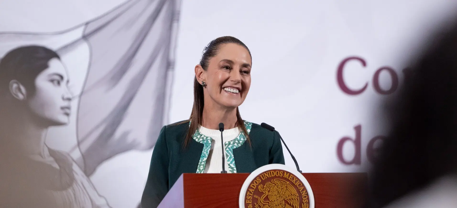 Smiling woman speaking at official podium