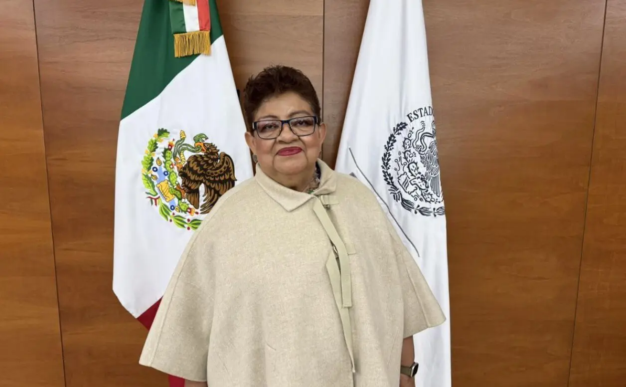 Smiling woman before Mexican flags