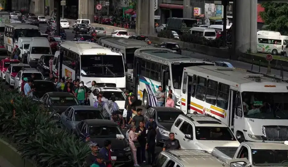 Busy city road with buses and commuters