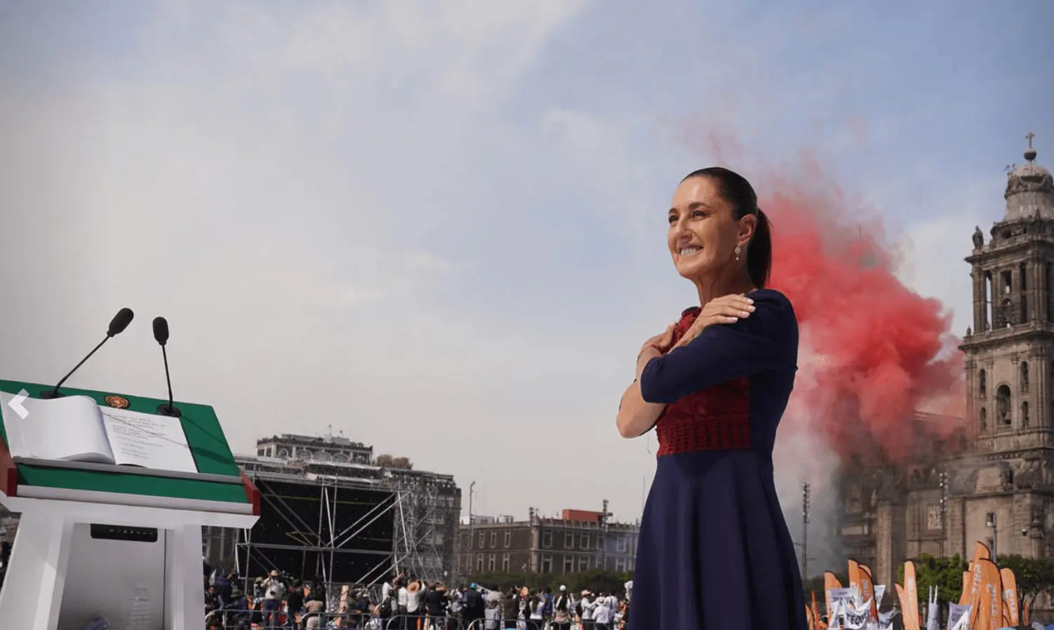 Woman smiling with red smoke behind her.