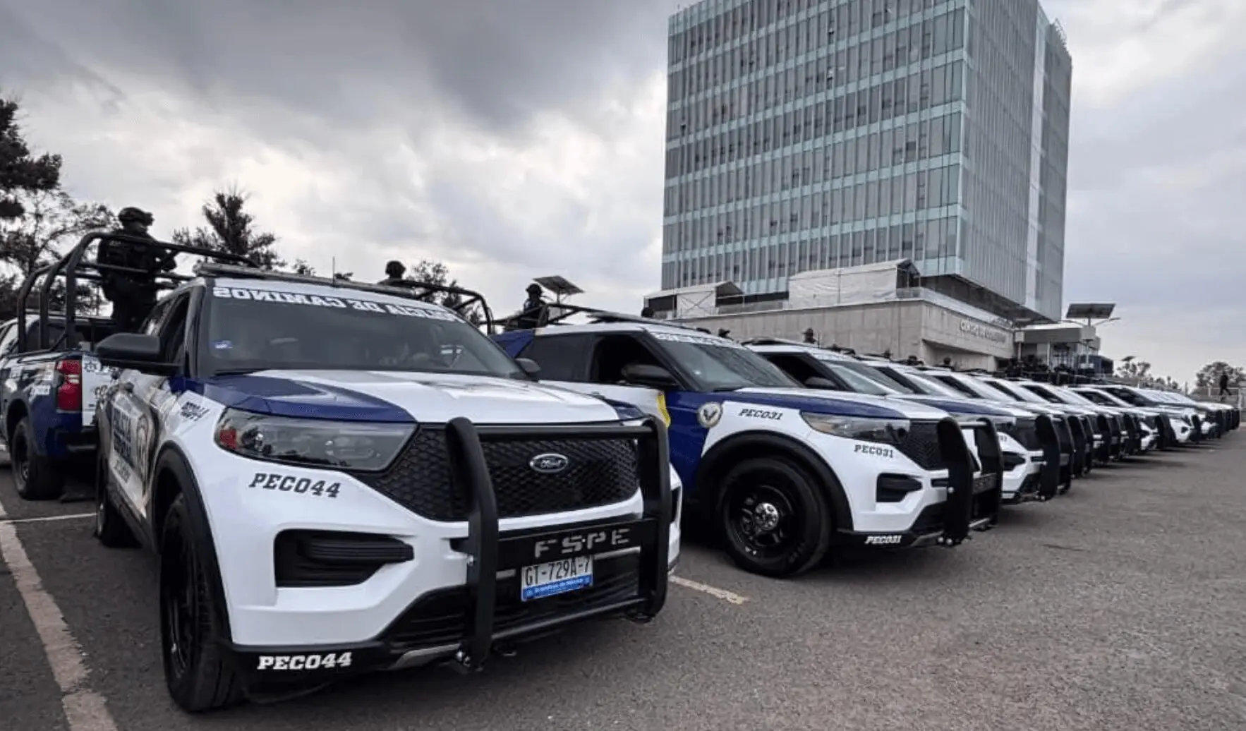 Police SUVs parked in a row outdoors.