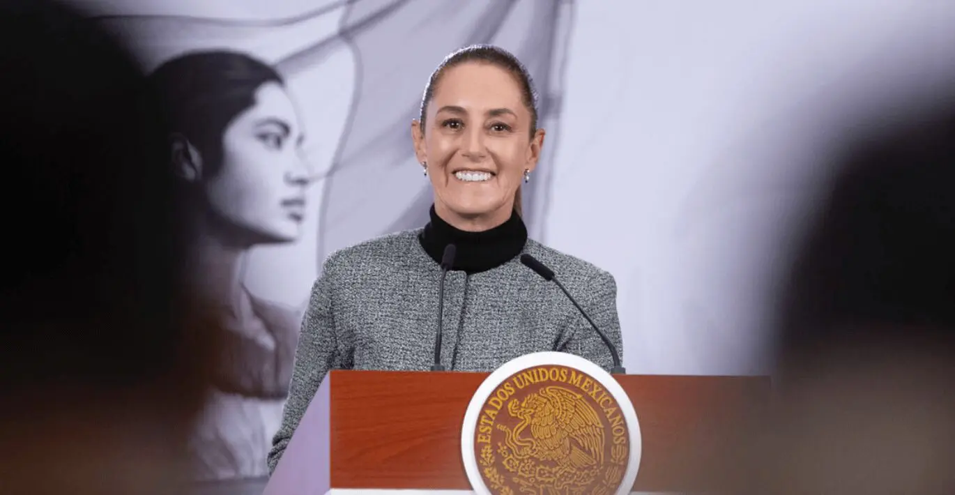 Woman smiling at podium with Mexican seal