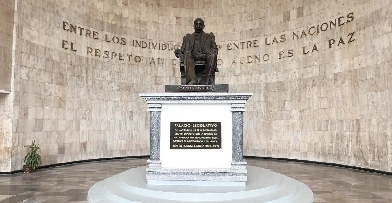 Bronze seated statue in circular marble memorial