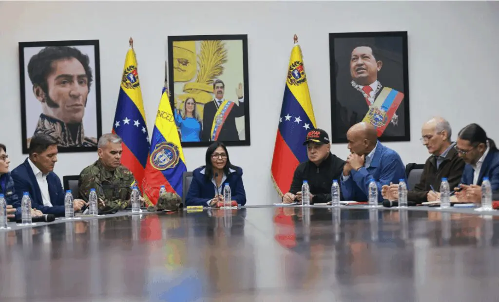 Officials meeting at table with flags