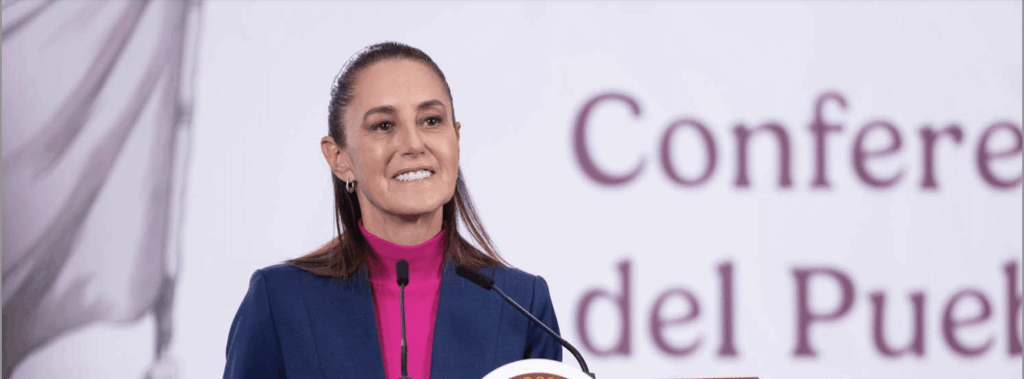 Woman in blue blazer at lectern smiling