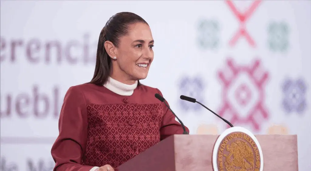 Smiling woman in embroidered red dress at podium