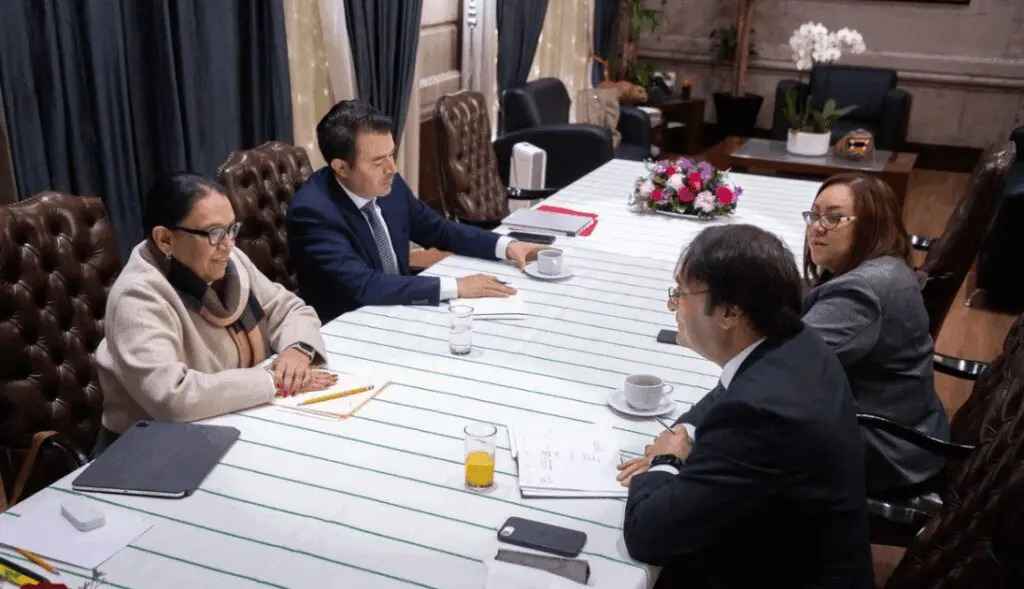 Four-person business meeting at conference table