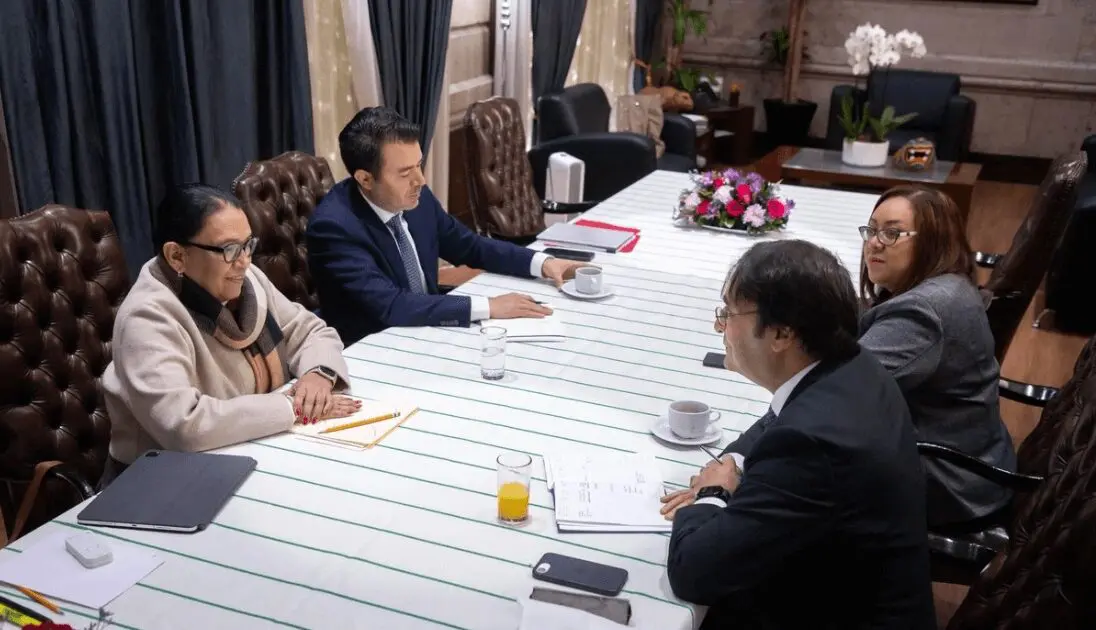 Four-person business meeting at conference table