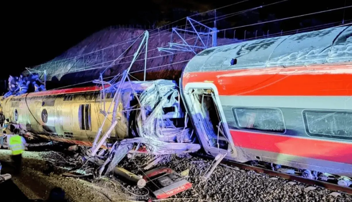 Derailed passenger trains wreckage under emergency lights