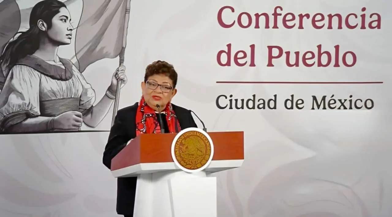 Ernestina Godoy frente a micrófono en conferencia