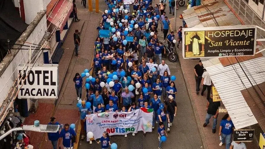 Aerial view of autism awareness march with balloons