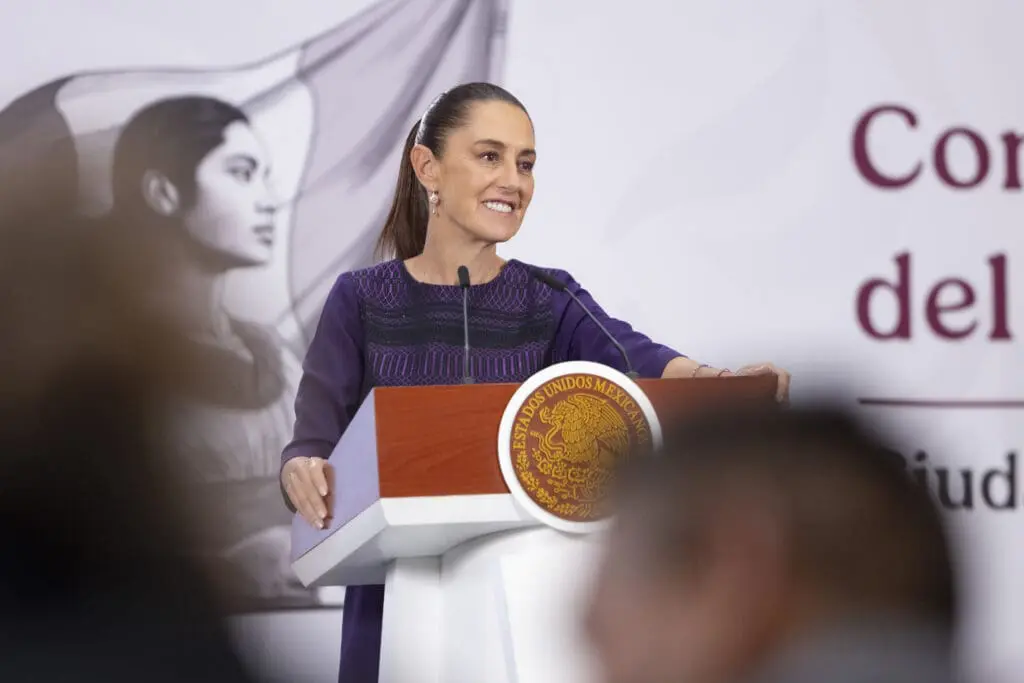 Woman smiling while speaking at podium