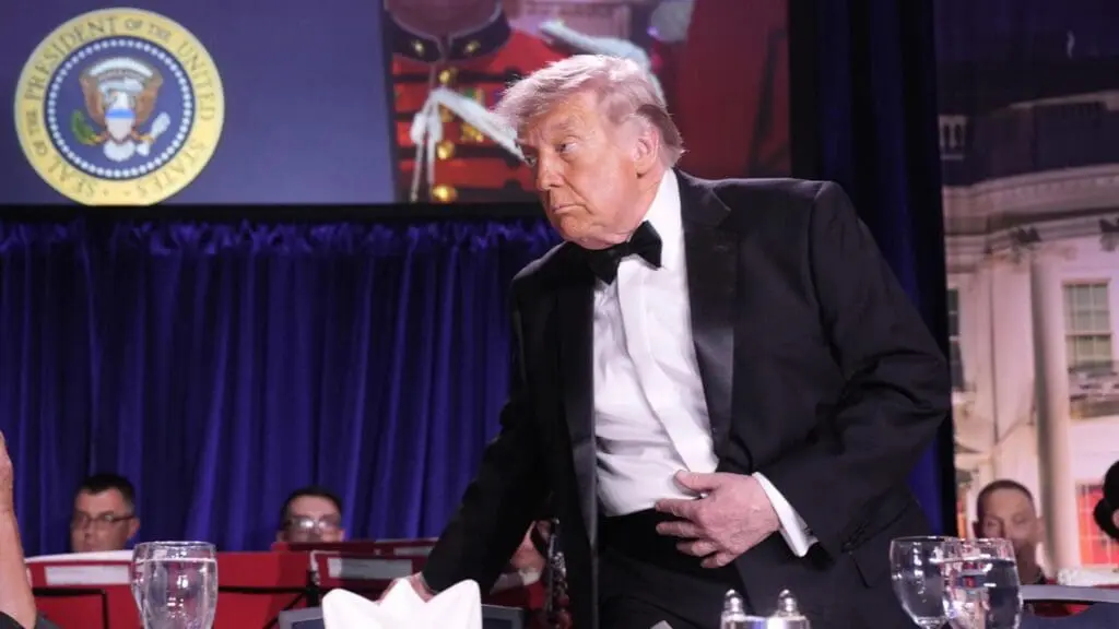 Man in tuxedo standing beside a banquet table