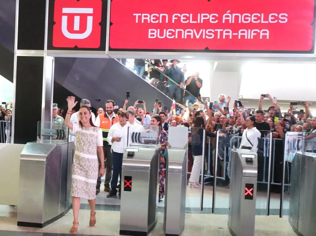 Woman waving to crowd at train station