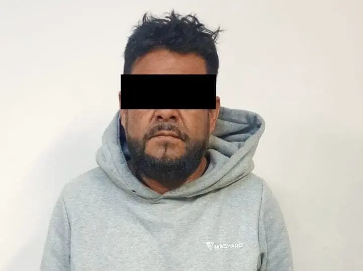 Man in gray hoodie with black censored eyes