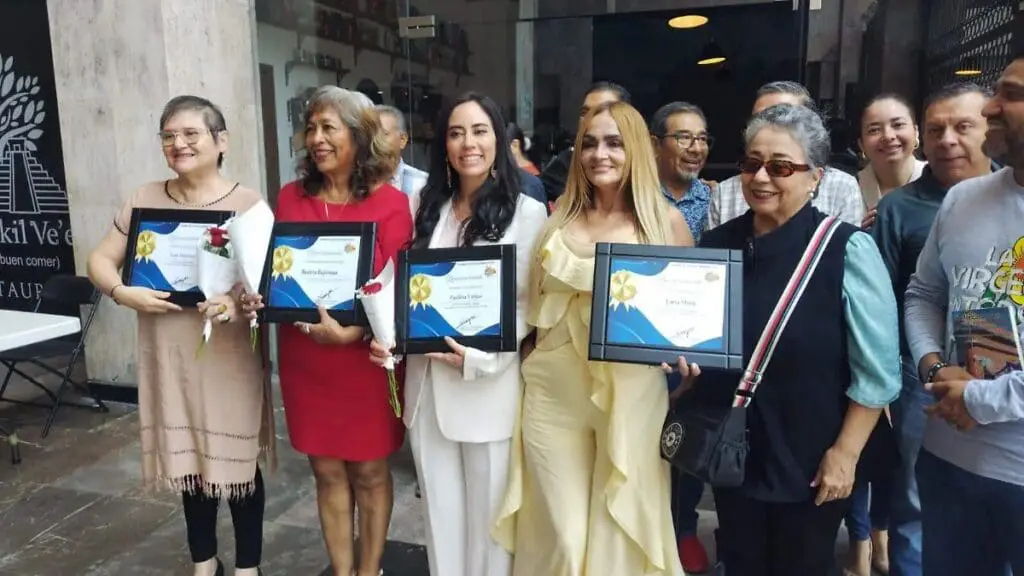 Group of women holding awards and flowers