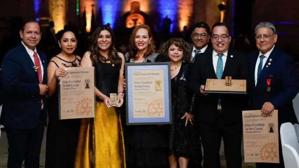 Group of people holding awards and certificates