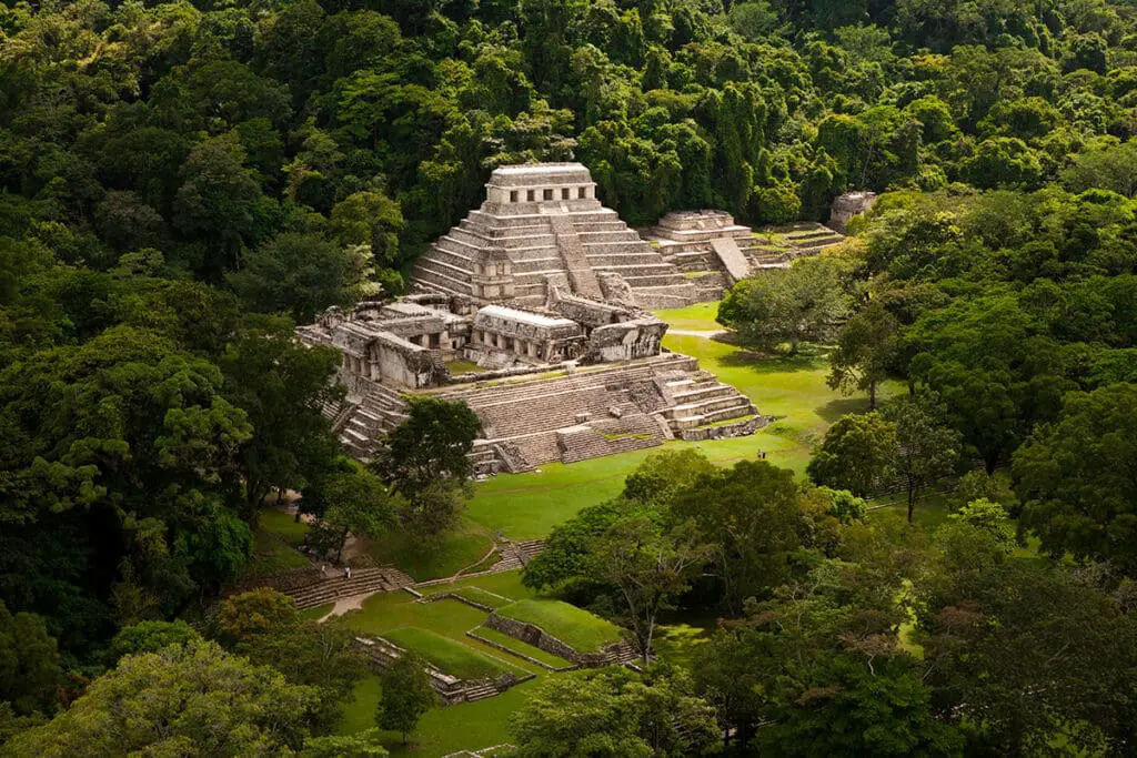 Ancient Mayan pyramid ruins surrounded by jungle