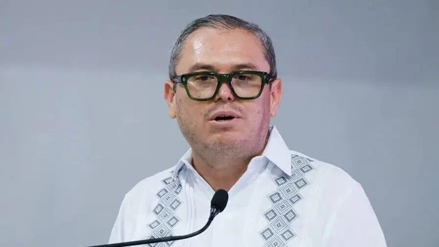 Man in embroidered white shirt at microphone