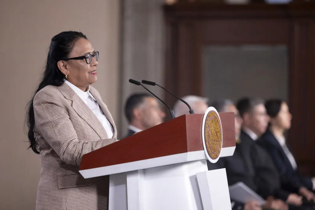 Woman speaking at podium in formal ceremony